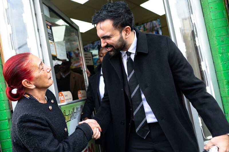 Mamdani greets a woman as he prepares to speak in the Belmont neighborhood of the Bronx on October 29th. Photograph: Michael M Santiago/Getty Images