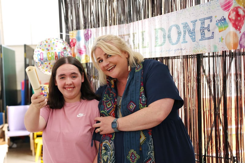 Maia O'Brien (18), holds her Senior Cycle results alongside Clare Carr, the principal of St Catherine's Special School in Newcastle, Co Wicklow. Photograph by Clodagh Kilcoyne/The Irish Times