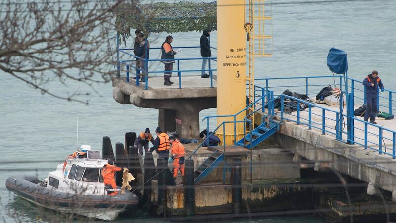 Russian Emergencies Ministry members work at a quay of the Black Sea near the crash site of a Russian military Tu-154 plane. Photograph: Reuters