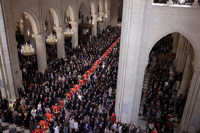 Firefighters, rescuers and builders involved in the restoration of Notre-Dame cathedral parade during the ceremony to mark the cathedral's reopening on Saturday. Photograph: Pascal Le Segretain/Getty Images