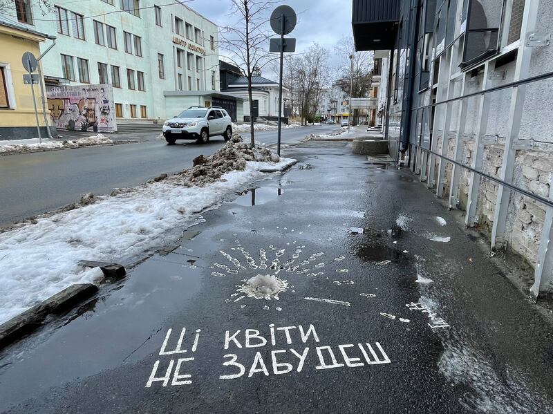 Kharkiv street artist Hamlet Zinkivskyi painted marks left in the pavement by a shell strike - which Sarajevo residents dubbed 'roses' during the 1992-5 Bosnian war - and added the words: 'You won't forget these flowers'. Photograph: Daniel McLaughlin