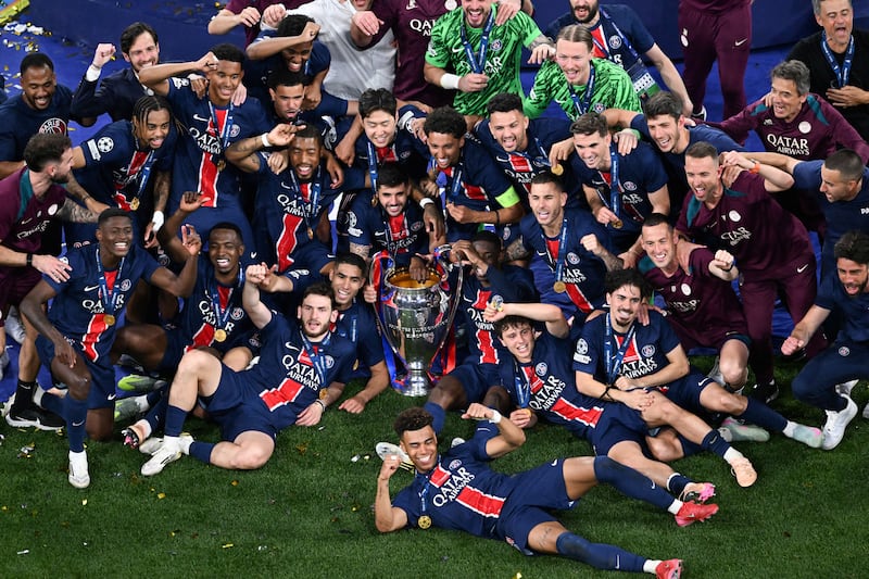 PSG celebrate with the Champions League trophy after beating Inter Milan in Munich. Photograph: Kirill Kudryavtsev/AFP via Getty Images