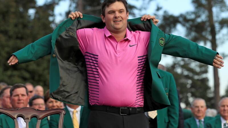 Patrick Reed  is presented with the green jacket by Sergio Garcia after winning the Masters in 2018. Photograph: Andrew Redington/Getty Images