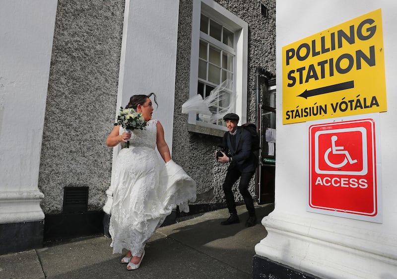 Veil Away: The effect of a gust of wind on Bride to be Aisling Barron who was en-route to getting married at the Church of St Vincent de Paul on Griffith Avenue; prior to the ceremony both Aisling and her father Ken voted at the Polling station in St Vincent de Paul Girl's school.  Photograph Nick Bradshaw/The Irish Times