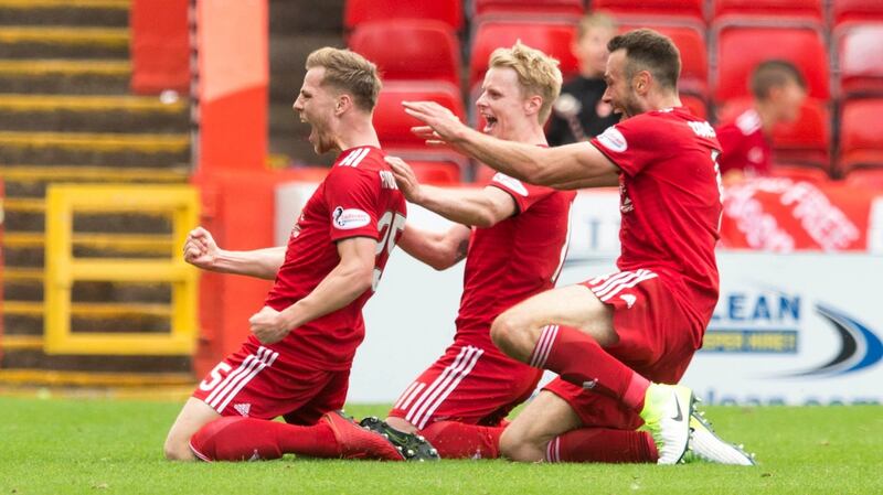 Aberdeen’s Bruce Anderson (left) celebrates scoring his side’s first goal with team-mates during the Scottish  Premiership match against Rangers at Pittodrie. Photograph: Jeff Holmes/PA Wire