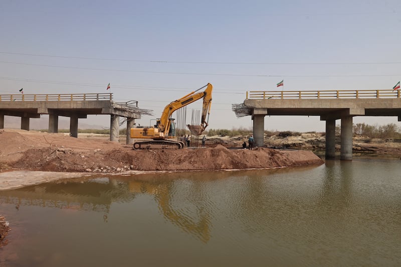 An excavator works on the Gachin Bridge, which was damaged by a US strike, along the road between Bandar Abbas and Bandar Khamir, in southern Iran on Tuesday. Photograph: Atta Kenare/AFP via Getty Images