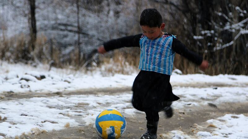 In this photograph taken in  January 2016, Afghan boy and Lionel Messi fan Murtaza Ahmadi (5) wears a plastic bag jersey as he plays football in Jaghori district of Ghazni province. Photograph: Getty