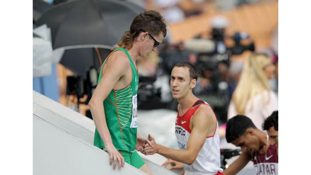 Ciaran O'Lionaird is congratulated by Canada's Geoffrey Martinson after finishing 6th in his heat of the men's 1500m. Photograph: Morgan Treacy/Inpho