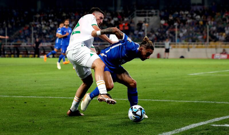 Republic of Ireland's Matt Doherty and Kostas Tsimikas of Greece during Friday's Euro 2024 qualifier at Opap stadium in Athens. Photograph: Ryan Byrne/Inpho