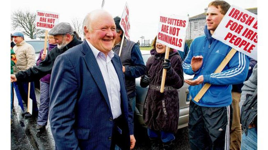 Padraic Byrne, of Killimor, is applauded by protesters after appearing in court in Loughrea, Galway, yesterday on charges over cutting of turf in an area of conservation. photograph: andrew downes