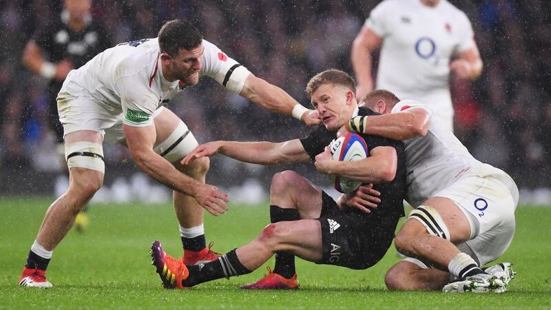 New Zealand’s  Damian McKenzie  is tackled by Brad Shields of England and Sam Underhill of England  at Twickenham. Kiwi Shields formerly  played for New Zealand’s U-20s. Photograph:  Laurence Griffiths/Getty Images