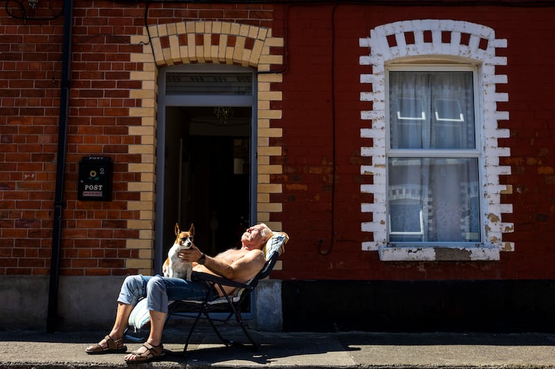 Paddy Moylan and Minni the terrierenjoying the sunshine on Somerset Street, Ringsend, Dublin, last week. Photograph: Tom Honan