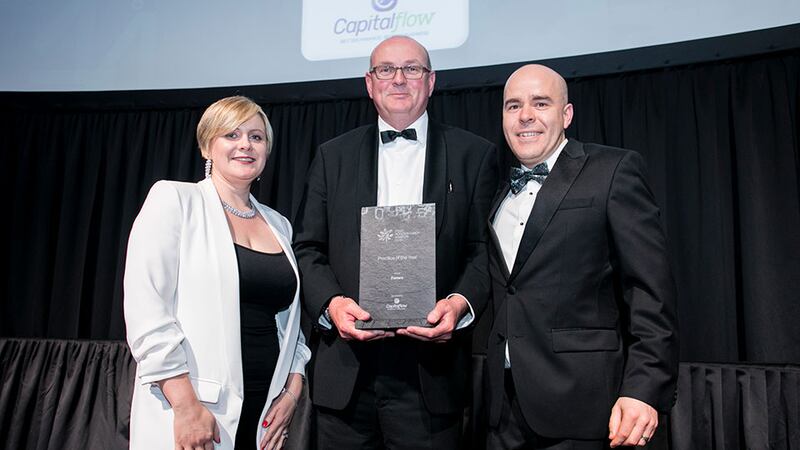 Colum Breslin, Managing Director, Capitalflow, presents the Practice of the Year award to Sinead Doherty & David O'Reilly, Fenero.