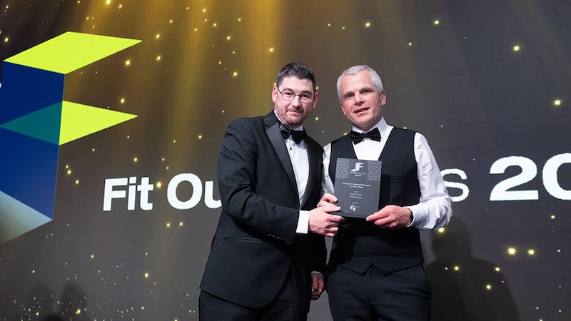 Ronan Schwer, commercial director at The Interiors Group, presents the fit out project manager of the year award to Chris Dunne, FKM Fit Out