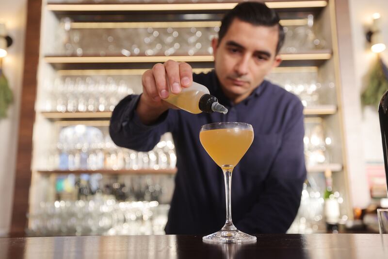 D'Olier Street restaurant manager Konrad Czlonka mixing an Oxidised Pear and Jerusalem Artichoke Martini as a nonalcoholic pairing with the Michelin-starred restaurant's tasting menu. Photograph: Alan Betson