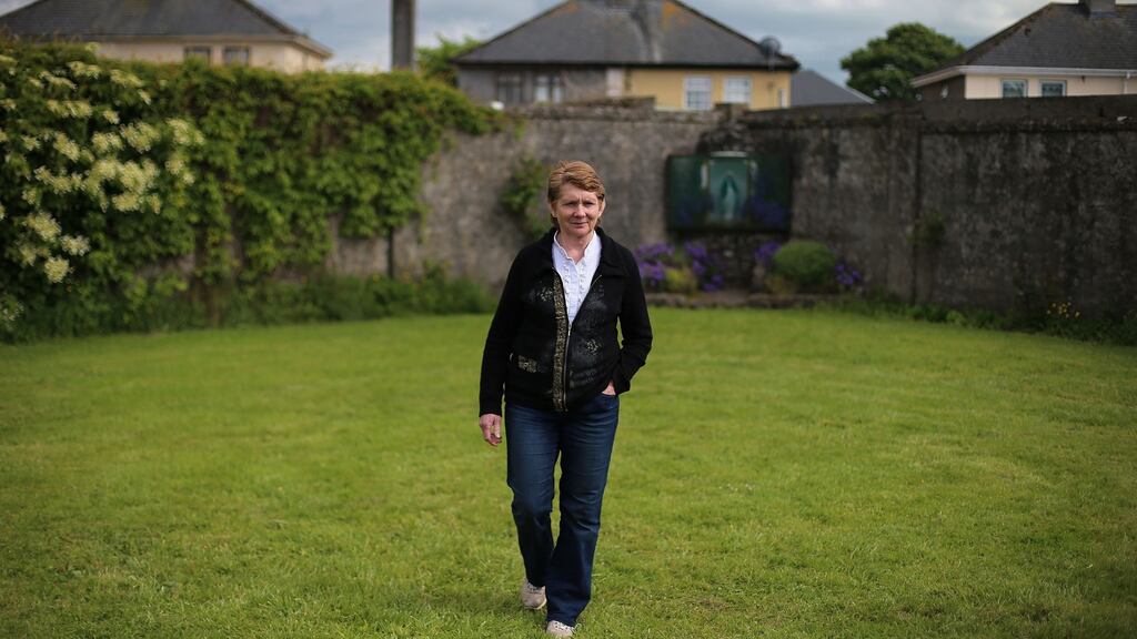 Historian Catherine Corless at the site of a mass grave for children who died in the Tuam mother and baby home, Co Galway: remains were contained in at least 17 of 20 underground chambers. Photograph: Niall Carson/PA Wire