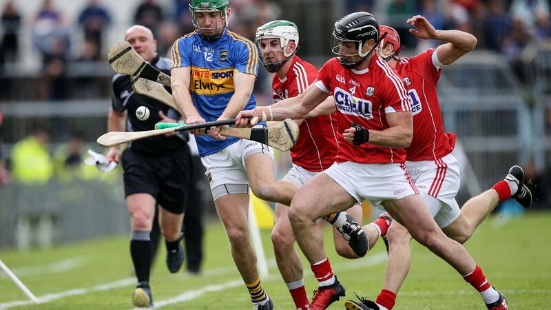 Tipperary’s Noel McGrath under pressure from Shane Kingston, Bill Cooper and Colm Spillane of Cork. Photograph: Cathal Noonan/INPHO