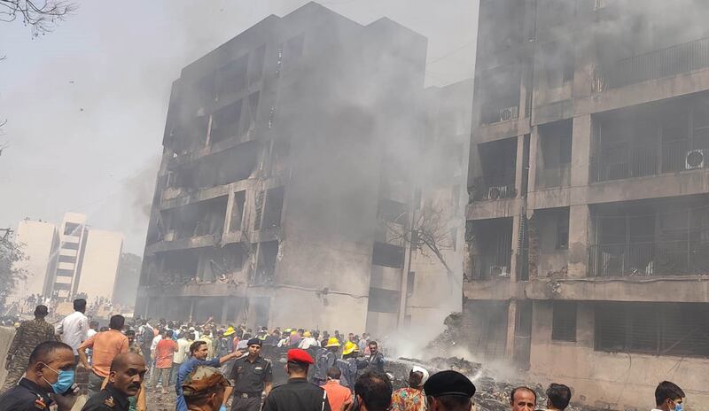 People and rescuers are seen at a site of a plane crash in Ahmedabad in India's Gujarat state. Photo by Xinhua/Shutterstock