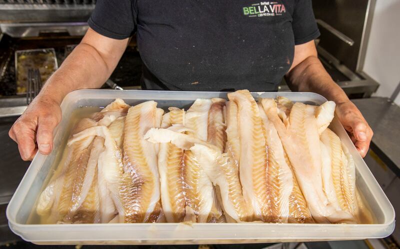 Sharon McGeown holds a tray of white fish at Nemo's chip shop in south Belfast. Photograph: Liam McBurney
