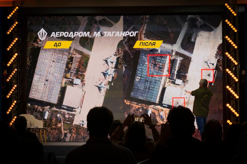 Images of the Russian airfield in Taganrog before and after an attack by Ukrainian drones are shown on a screen in Kyiv. Photograph: Dan Bashakov/Global Images Ukraine via Getty Images