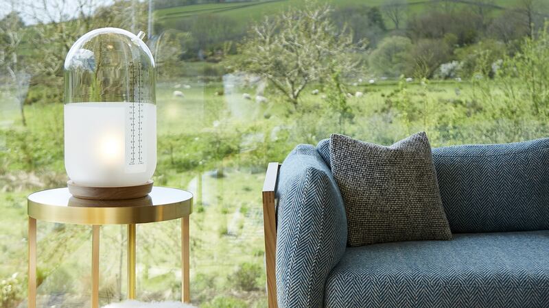 A DC sofa takes centre stage in the living room, the glass walls of which  frame the Co Antrim foothills.