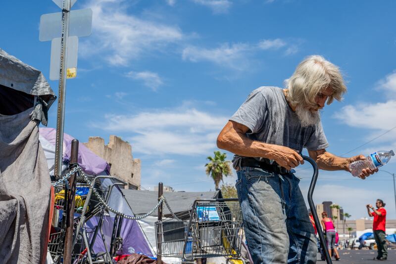 A man receives water from volunteers on Friday in Phoenix. Photograph: Brandon Bell/Getty Images