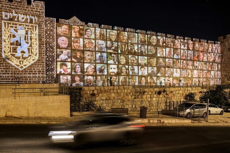 Pictures of the hostages abducted by Palestinian militants projected on the walls of the old city of Jerusalem. Photograph: Ahmad Gharabli/AFP via Getty Images