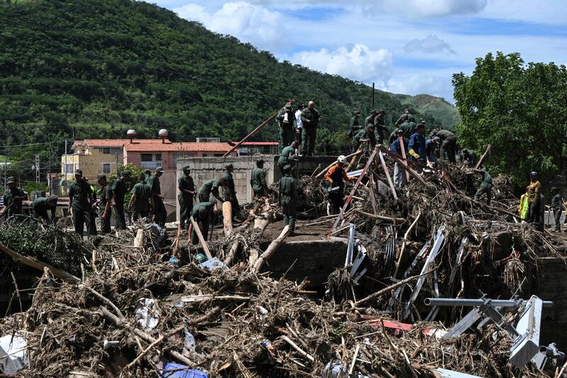 Venezuelan soldiers search the rubble of houses after a landslide during heavy rains in Las Tejerias, Aragua state, Venezuela, on October 10th, 2022. Photograph: YURI CORTEZ/AFP via Getty Images