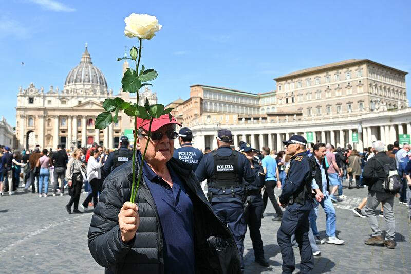 A man holding a white rose stands in St Peter's square in Rome following the death of Pope Francis. Photo: Getty Images       