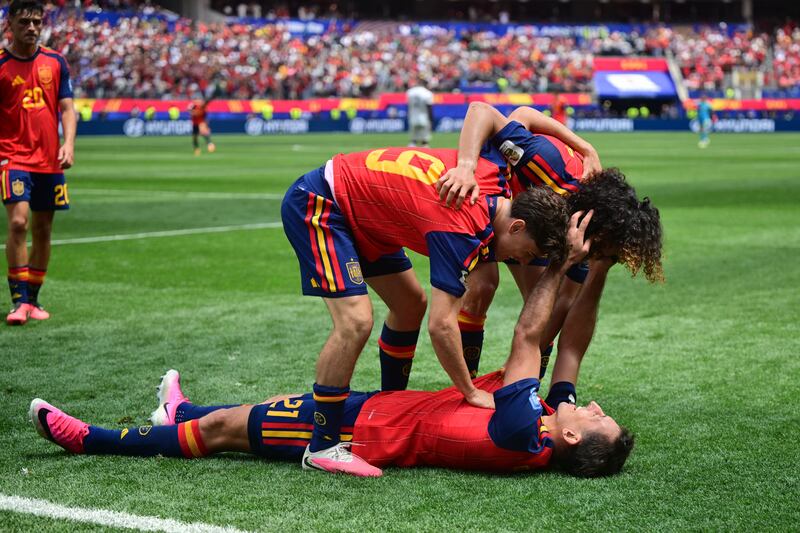 Mikel Oyarzabal celebrates scoring with Gavi and Marc Cucurella. Photograph: Frederic J Brown/AFP via Getty