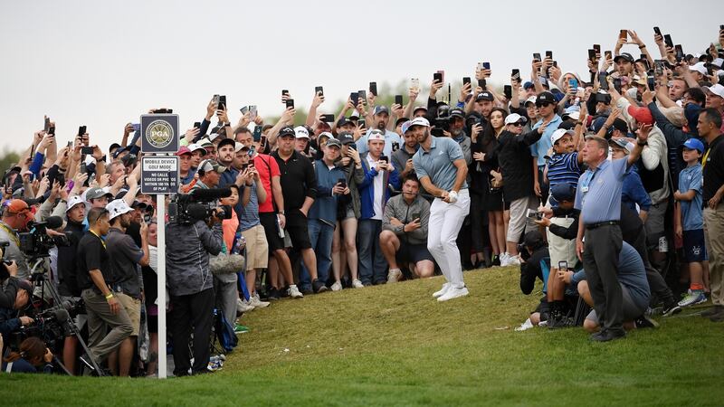 Johnson plays his third shot on the 18th. (Photo by Ross Kinnaird/Getty Images)