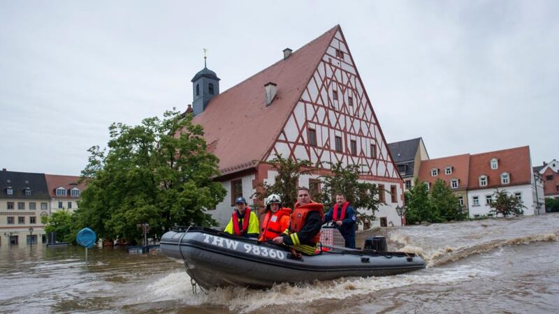 Firefighters and helpers evacuate inhabitants in the flooded city centre of Grimma, Germany, yesterday.  Photograph: Jens Schlueter/Getty Images