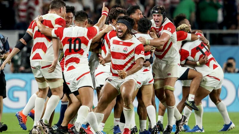 Japan celebrate at the final whistle after their 19-12 win over Ireland. Photogaph: Dan Sheridan/Inpho