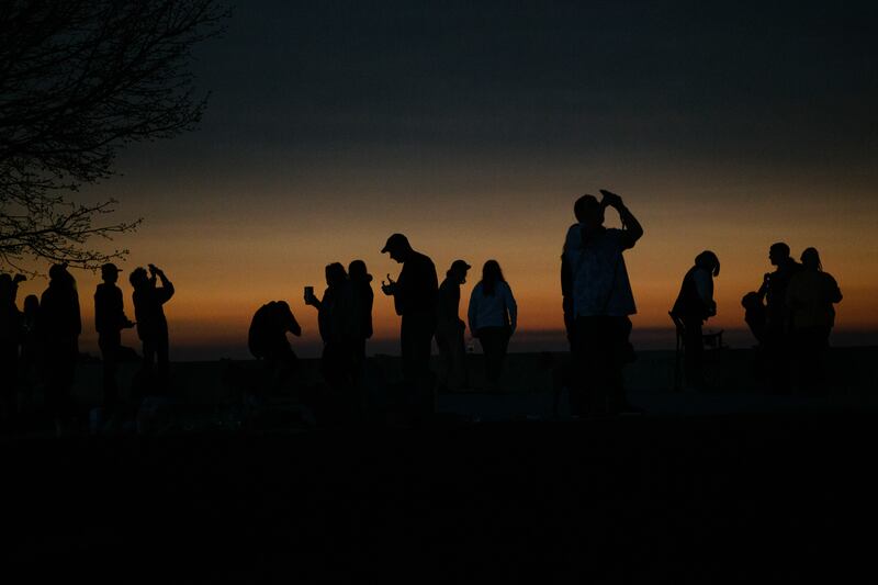  People view the solar eclipse during totality at Perry’s Victory & International Peace Memorial in Put-in-Bay, Ohio, Monday, April 8, 2024. (Madeleine Hordinski/The New York Times) 