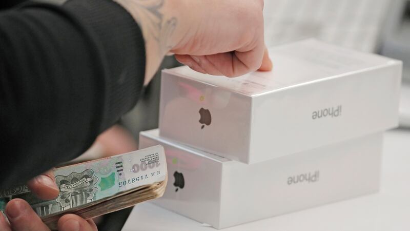 An Apple staff member counts a customer’s money as they pay for a new iPhone X at an Apple shop during its launch in Moscow, Russia,  on November 3rd, 2017.  Photograph: Sergei Ilnitsky.