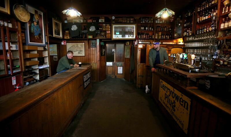 Owner Finn MacDonnell with Seamus O Grifín as he enjoys his first pint in Dick Mack's pub in Dingle, Co Kerry, as 'wet' pubs reopen outside Dublin after the Covid-19 lockdown restrictions were imposed in March 2020. Photograph: Laura Hutton