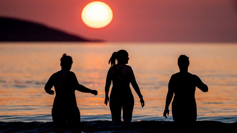 Three amigas: Early morning swimmers at sunrise on Sunday at Portmarnock Beach in Dublin. Photograph: Tom Honan