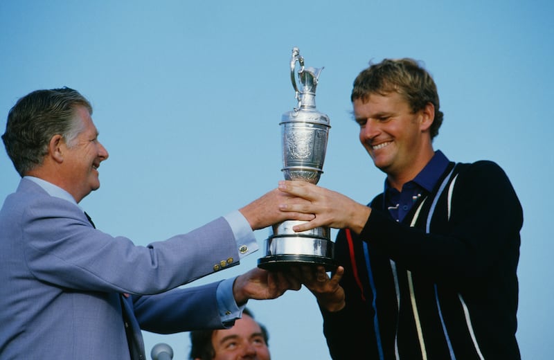 Scottish golfer Sandy Lyle receives the British Open trophy from Angus Lloyd, Captain of St George's, at the Royal St George's Golf Club, July 1985. Photograph: Trevor Jones/Getty Images