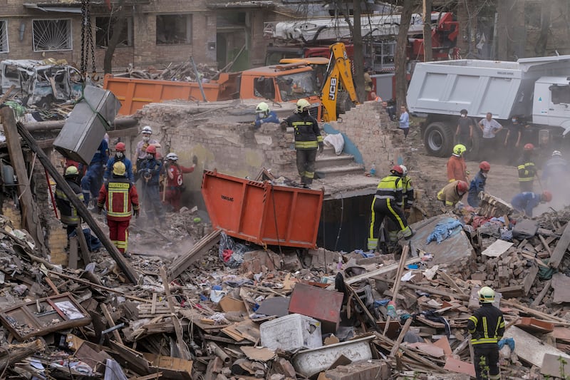 Ukrainian emergency workers clear rubble and search for victims at the site of a Russian missile strike in Kyiv on April 24. Photograph: Brendan Hoffman/The New York Times
