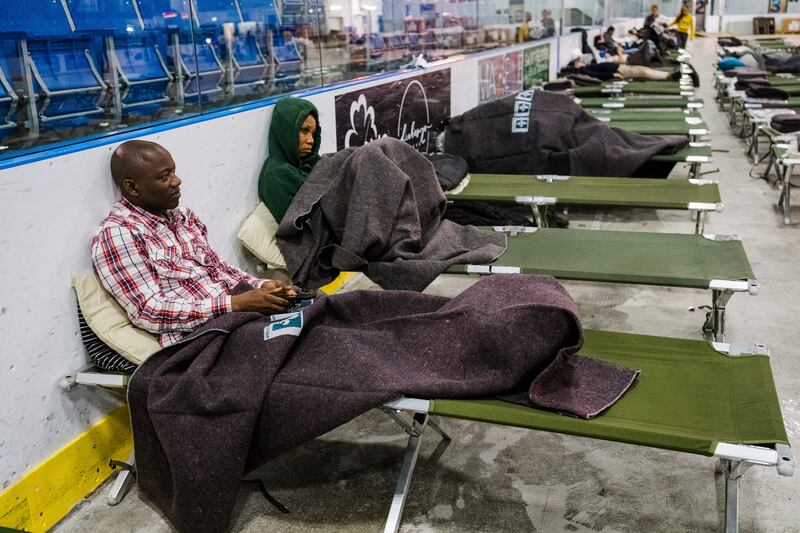 Rey Steve Mabiala and his wife, Liz Gouari, take refuge from the fires at the Roberval emergency center, in Quebec, Canada, on June 7th. Photograph: Renaud Philippe/The New York Times