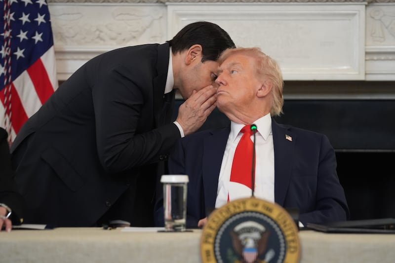 US secretary of state Marco Rubio whispers to President Donald Trump in the State Dining Room at the White House in Washington (Evan Vucci/AP)