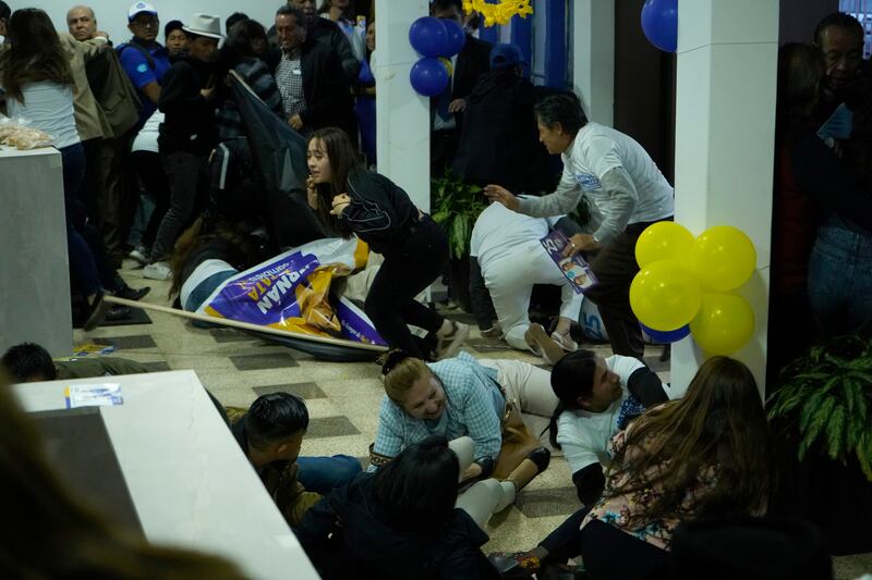 Supporters of presidential candidate Fernando Villavicencio run for cover after the shooting on Wednesday night. Photograph: API via AP