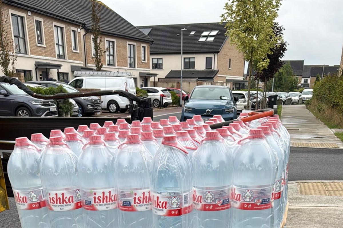 Bottled water distributed to housing-estate residents complaining of ongoing supply fault