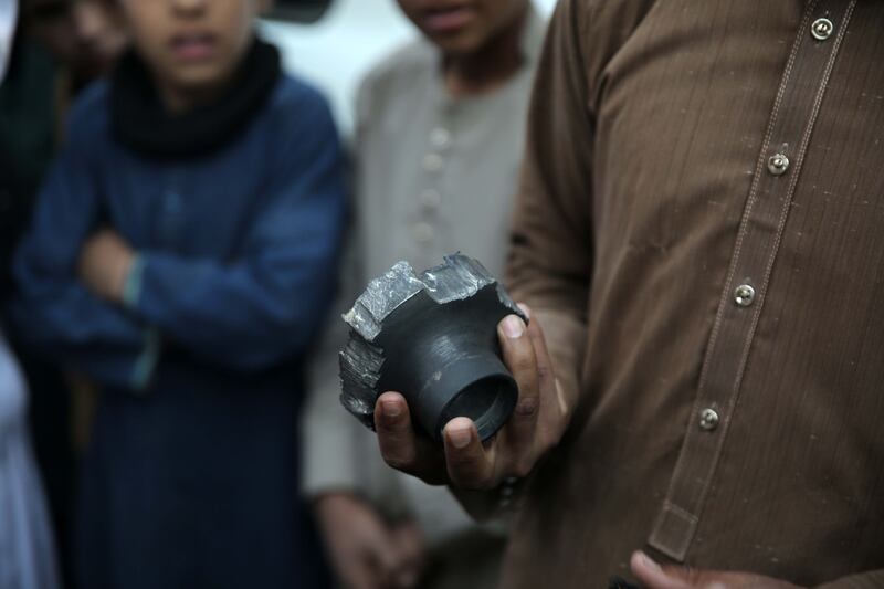 Locals examine an object found after alleged overnight Pakistani airstrikes in the Ghani Khel district of Nangarhar province, Afghanistan. Photograph: EPA