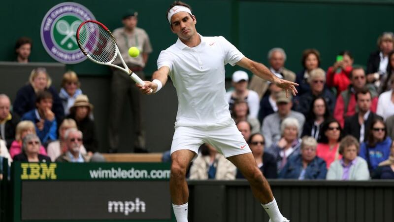 Roger Federer   plays a forehand during his singles first round match against Victor Hanescu  on day one of  Wimbledon. Photograph: Clive Brunskill/Getty Images