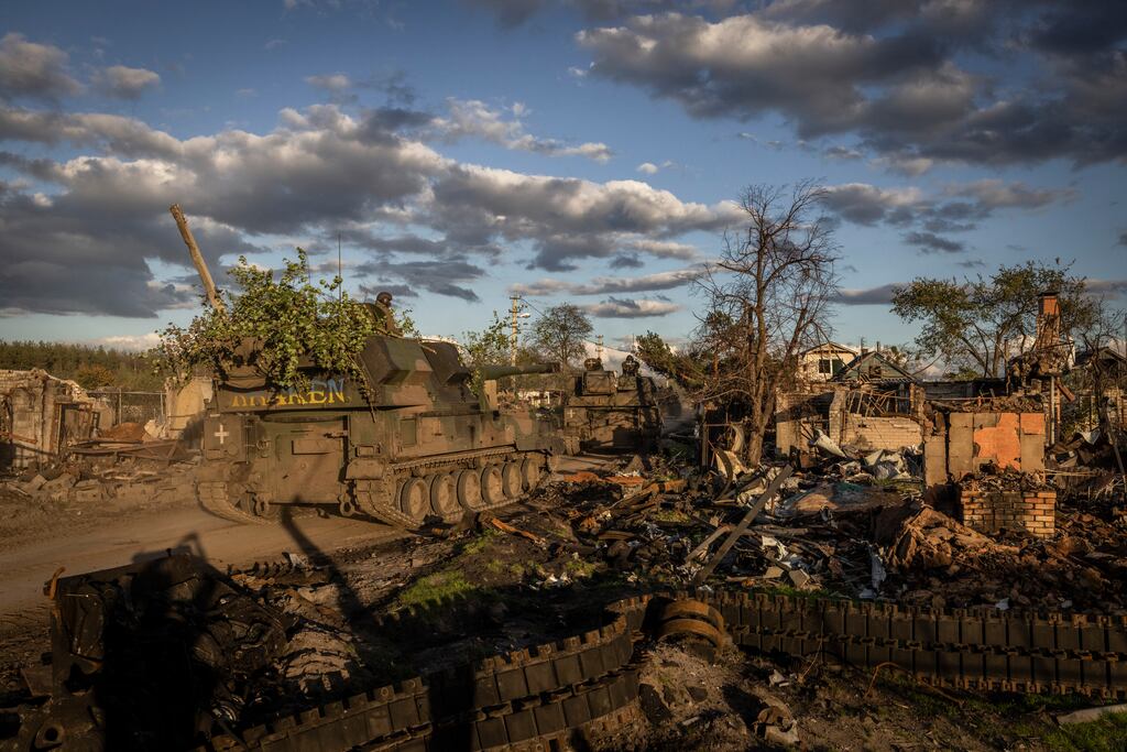A column of Ukrainian tracked howitzers moves through the recently recaptured village of Yatskivka and toward the front line, in the Donetsk region of Ukraine. Photograph: Ivor Prickett/The New York Times