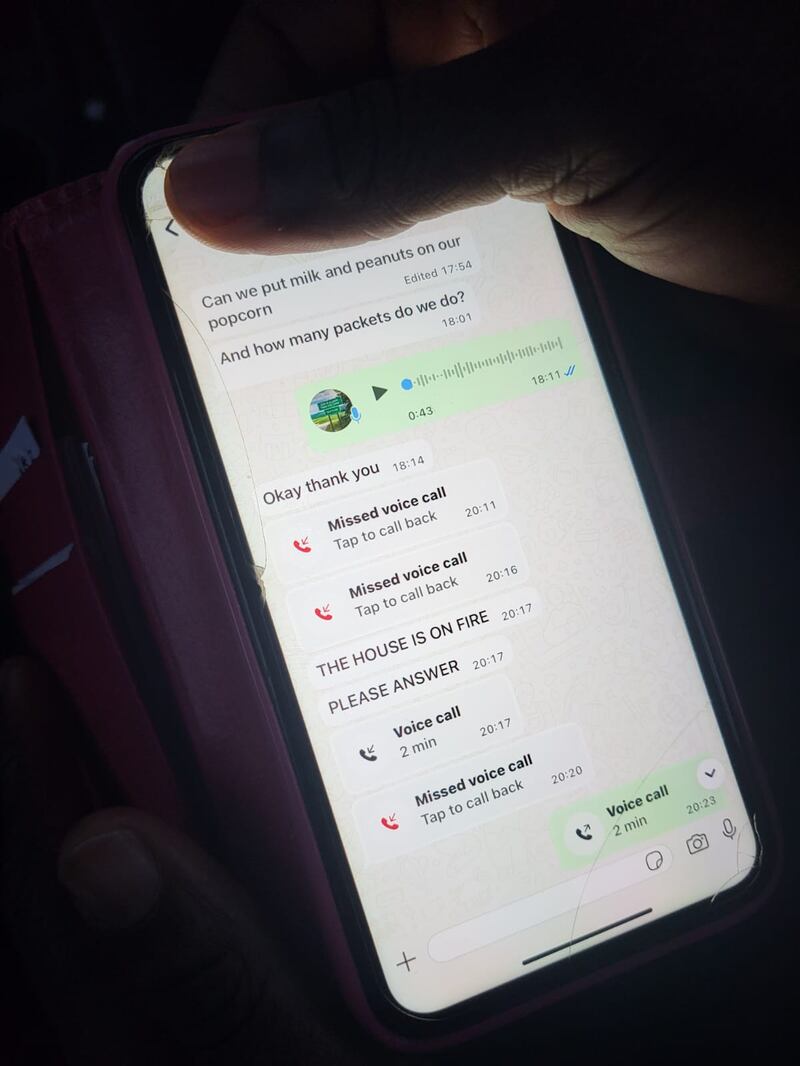 A mother holds her phone showing messages received from one of her children who was in the centre when the fire started. Photograph: Kitty Holland