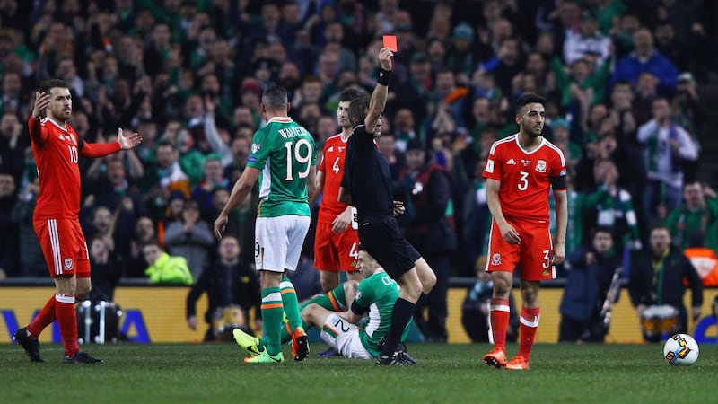 Neil Taylor is shown a red card for his tackle on Seamus Coleman. Photo: Ian Walton/Getty Images