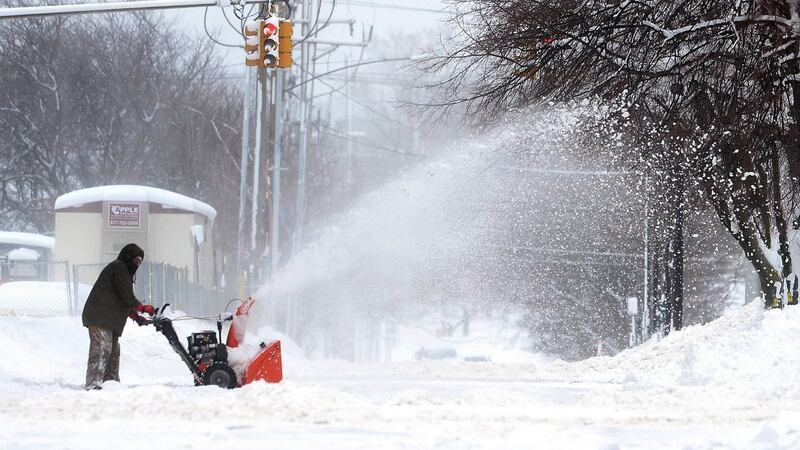 A man clears snow on Tuesday in Erie. Photograph: Greg Wohlford/Erie Times-News via AP