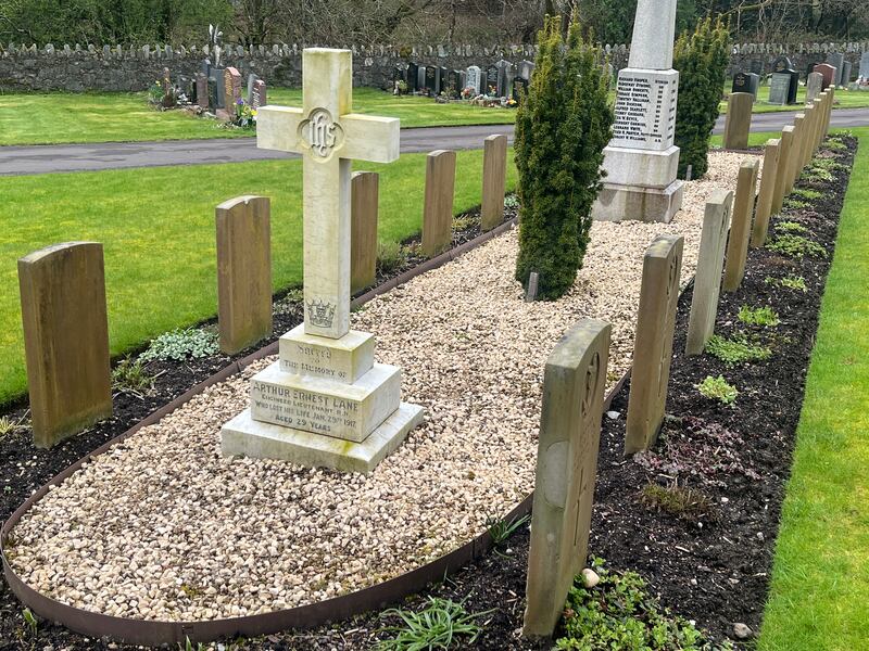 The submarine-shaped memorial and headstones at Faslane cemetery in memory of the 1917 disaster in the nearby loch. Photograph: Mark Paul